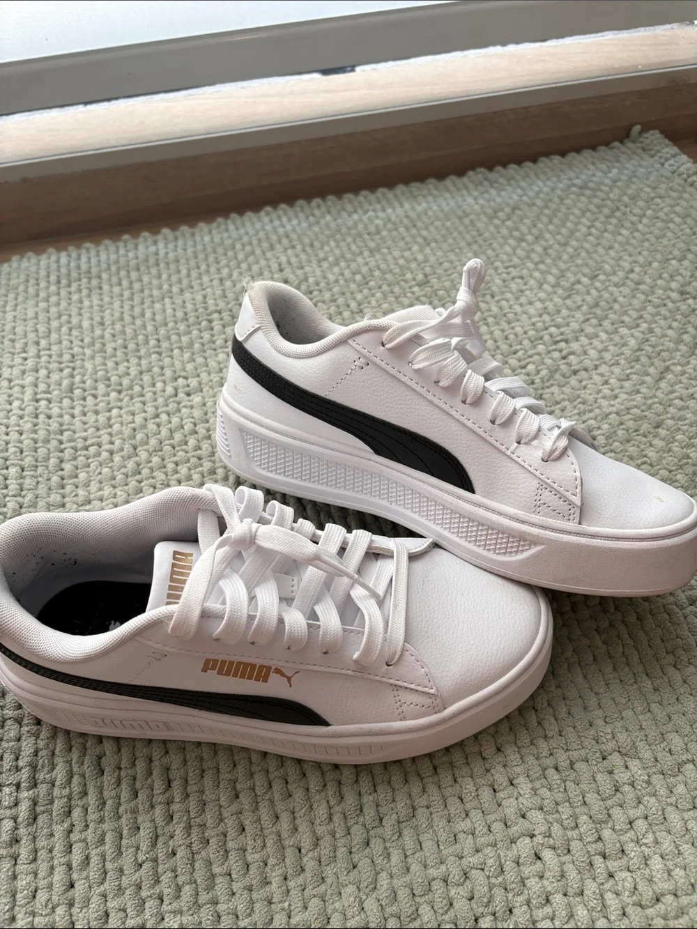 Puma White Low-Top Sneakers with Black Stripe and Gold Logo